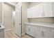 Bright laundry room with white cabinetry and marble countertops for added elegance at 2264 Savannah River St, Henderson, NV 89044