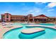 Community pool area with comfortable lounge chairs and beautiful clubhouse backdrop at 2264 Savannah River St, Henderson, NV 89044