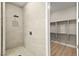 Modern tiled shower with rain shower head and glass door near walk-in closet at 2264 Savannah River St, Henderson, NV 89044