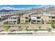 Aerial view of homes with putting greens with mountains in the background at 244 Native Stone St, Las Vegas, NV 89138