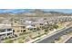 Aerial view of community showcasing modern homes and landscaping against a mountain backdrop at 244 Native Stone St, Las Vegas, NV 89138