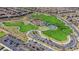 Aerial view of a park, playground and parking lot in a Primary planned community at 244 Native Stone St, Las Vegas, NV 89138