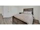 Bedroom with a queen bed and wood-look flooring near a closet with sliding doors at 244 Native Stone St, Las Vegas, NV 89138