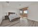 Bedroom with balcony access and wood-look flooring featuring a neutral color scheme and recessed lighting at 244 Native Stone St, Las Vegas, NV 89138