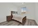Bedroom with wood-look flooring, a double bed, a nightstand, and a large window at 244 Native Stone St, Las Vegas, NV 89138