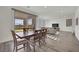 Dining area with wood table and chairs adjacent to sliding glass doors to back patio at 244 Native Stone St, Las Vegas, NV 89138
