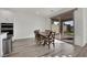 Bright dining room features wood floors and a sliding glass door leading to outdoor space at 244 Native Stone St, Las Vegas, NV 89138