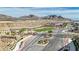 Gated entrance to a new community with landscaped median and desert landscape at 244 Native Stone St, Las Vegas, NV 89138