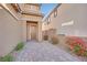 Close-up of a home's entrance with a paved pathway, desert plants, and a stylish front door at 244 Native Stone St, Las Vegas, NV 89138