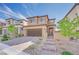 Beautiful two-story home with a modern design, attractive brick driveway, and low-maintenance desert landscaping at 244 Native Stone St, Las Vegas, NV 89138