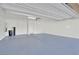 Clean, well-lit garage interior with white walls, blue epoxy floor, and modern garage door at 244 Native Stone St, Las Vegas, NV 89138