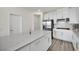 Spacious kitchen with large island, white cabinetry, and stainless steel appliances at 244 Native Stone St, Las Vegas, NV 89138