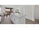 Open concept living space with kitchen island, dining area, and stainless appliances at 244 Native Stone St, Las Vegas, NV 89138