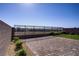 Landscaped backyard features a retaining wall with wrought iron view fence and desert landscaping at 2581 Tolmezzo St, Henderson, NV 89044