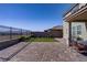 Large backyard features patio, retaining wall with wrought iron view fence and well manicured landscaping at 2581 Tolmezzo St, Henderson, NV 89044