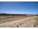 Backyard view features desert landscape, mountains in the distance and other homes in the community at 2581 Tolmezzo St, Henderson, NV 89044
