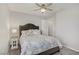 Bedroom with a ceiling fan, neutral walls, carpet flooring, and a patterned comforter at 2581 Tolmezzo St, Henderson, NV 89044