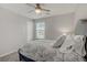 Bedroom with a ceiling fan, neutral walls, carpet flooring, and a patterned comforter at 2581 Tolmezzo St, Henderson, NV 89044