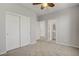 Carpeted bedroom with a ceiling fan, closet, and ensuite bathroom at 2581 Tolmezzo St, Henderson, NV 89044