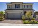 Charming two-story home featuring a brick driveway, two-car garage, and manicured landscaping at 2581 Tolmezzo St, Henderson, NV 89044