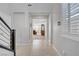 Inviting hallway with tile flooring, leading to a bright living space with shuttered windows at 2581 Tolmezzo St, Henderson, NV 89044