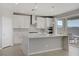 Modern kitchen with white cabinets, stainless steel appliances, and a large center island with seating at 2581 Tolmezzo St, Henderson, NV 89044