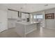 Spacious kitchen boasts a center island, stainless steel appliances, and a door to the patio at 2581 Tolmezzo St, Henderson, NV 89044
