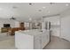Modern kitchen with a large center island, white cabinets, and seamless flow to the living area at 2581 Tolmezzo St, Henderson, NV 89044