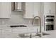 Close-up of kitchen features stainless steel appliances, white cabinets, and marble countertops at 2581 Tolmezzo St, Henderson, NV 89044
