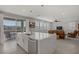 Bright, open kitchen with a large island, stainless steel appliances, and sliding glass doors to the patio at 2581 Tolmezzo St, Henderson, NV 89044