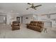 Expansive living space featuring leather seating, ample lighting, and an open layout to the kitchen at 2581 Tolmezzo St, Henderson, NV 89044