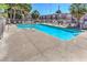 Sparkling community pool surrounded by lounge chairs and manicured grounds, perfect for relaxation and recreation at 2620 Sierra Seco Ave # 101, Las Vegas, NV 89106
