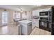 Modern kitchen featuring stainless steel appliances, white cabinets, and quartz countertops at 2620 Sierra Seco Ave # 101, Las Vegas, NV 89106