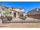 Brick backyard with dining set, grill, and black metal fencing at 2657 Fawn Beige Ct, North Las Vegas, NV 89086
