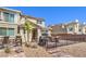 Brick backyard with dining set, lounge swing, grill, and black metal fencing at 2657 Fawn Beige Ct, North Las Vegas, NV 89086