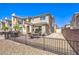 Brick backyard with dining set, lounge swing, grill, and black metal fencing at 2657 Fawn Beige Ct, North Las Vegas, NV 89086