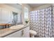Stylish bathroom boasts a modern vanity, sleek mirror, and contemporary shower curtain for added flair at 2657 Fawn Beige Ct, North Las Vegas, NV 89086