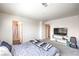 Cozy bedroom showcasing wall-mounted tv, light carpet, and serene setting at 2657 Fawn Beige Ct, North Las Vegas, NV 89086