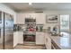 Modern kitchen featuring stainless steel appliances, granite countertops, and white cabinetry at 2657 Fawn Beige Ct, North Las Vegas, NV 89086
