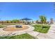 Community playground with shade cover, slide, and fun, imaginative play equipment amidst lush landscaping at 2657 Fawn Beige Ct, North Las Vegas, NV 89086
