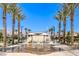 Community splash pad featuring picnic tables, benches, and ample space for relaxation on a beautiful sunny day at 2657 Fawn Beige Ct, North Las Vegas, NV 89086