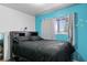 A bright bedroom featuring a bed with drawer storage and a large window at 2809 Webster St, North Las Vegas, NV 89030