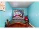 A classic bedroom features hardwood floors, a wooden bed frame, and a bright window at 2809 Webster St, North Las Vegas, NV 89030