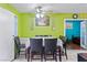 Dining room featuring tile floors, vibrant green walls, ceiling fan, and an open door to a bedroom at 2809 Webster St, North Las Vegas, NV 89030