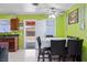 Dining room featuring tile floors, vibrant green walls, ceiling fan, and a table with chairs at 2809 Webster St, North Las Vegas, NV 89030