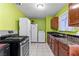 A compact kitchen featuring tile floors and a full appliance package at 2809 Webster St, North Las Vegas, NV 89030