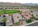 Expansive aerial view of a luxury home near a golf course, showcasing stunning mountain views and the neighborhood at 2885 Red Springs Dr, Las Vegas, NV 89135