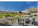 Beautiful backyard featuring a fire pit, lounge chairs, desert landscaping, and golf course views at 2885 Red Springs Dr, Las Vegas, NV 89135