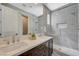 Modern bathroom with a double sink vanity, large mirror, and luxurious walk-in shower at 2885 Red Springs Dr, Las Vegas, NV 89135