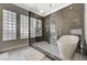 Spa-like bathroom with glass block windows, walk-in shower, and modern freestanding tub at 2885 Red Springs Dr, Las Vegas, NV 89135
